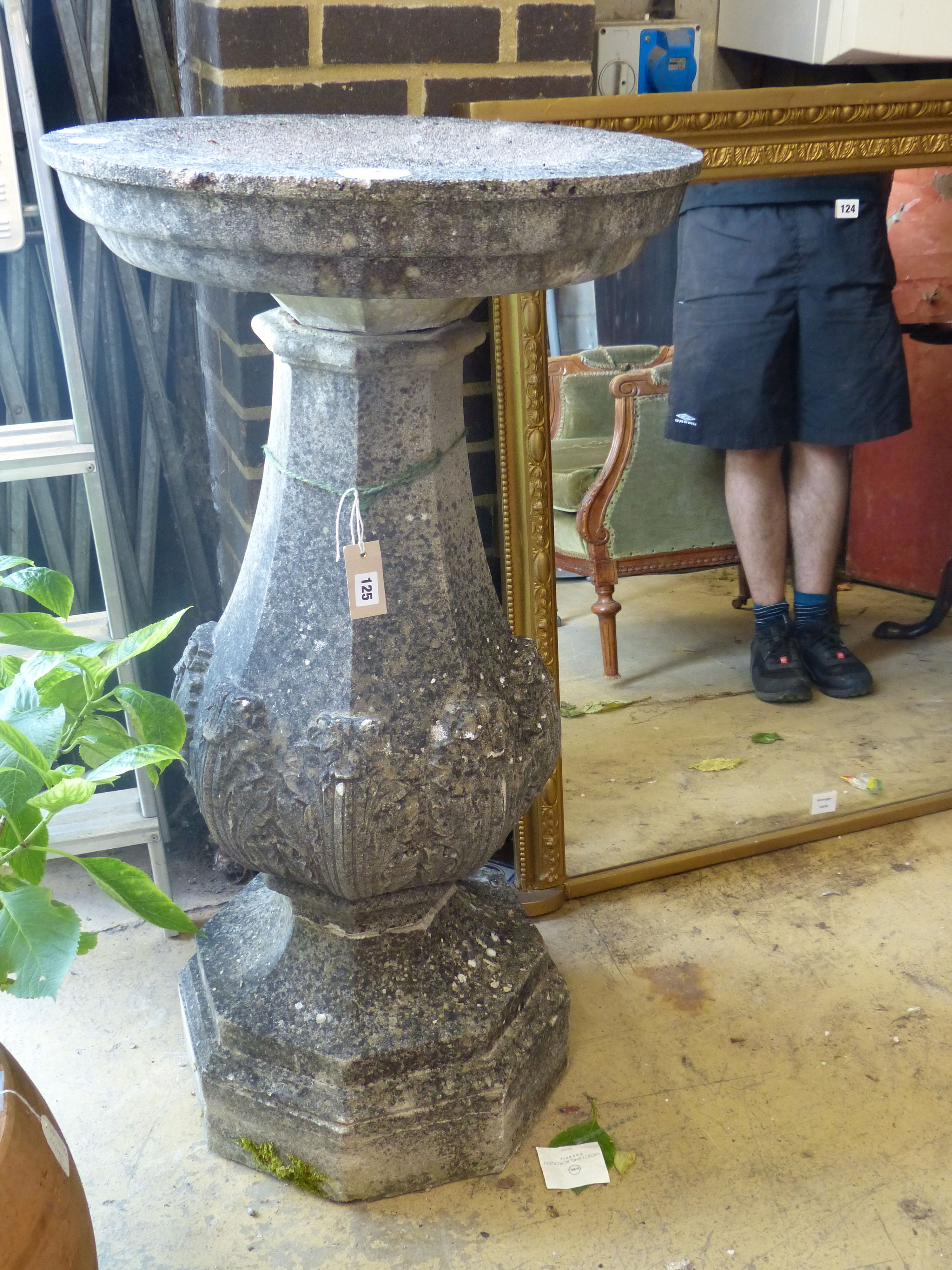 A reconstituted stone bird bath